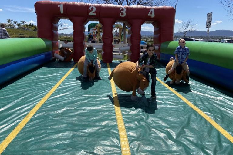 Spring Fest children participating in inflatable activity