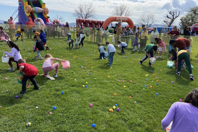 Spring Fest 2023 at Central Par. Children and family members collecting eggs in egg hunt.