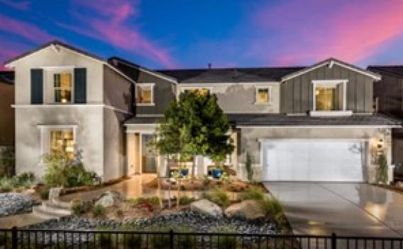 A modern two-story house at twilight features a manicured garden and driveway, under a vibrant pink and blue sky, exuding a serene ambiance.